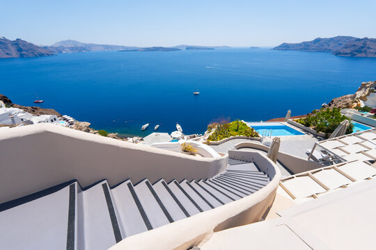 White architecture in Santorini island, Greece. Stairs to the sea. Blue sea and the blue sky at sunny day