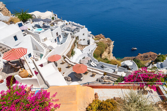 Santorini island, Greece. Beautiful terrace with flowers and sea view at sunny day.