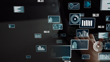 Naklejka premium A close-up view of a user hand working on a laptop, surrounded by digital graphics of financial metrics, data visualization, and analytics on a transparent display. Xenic