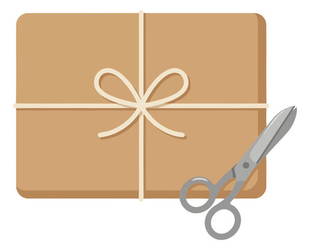 Parcel package wrapped in brown paper with string and scissors
