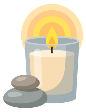 Scented candle in glass with spa stones