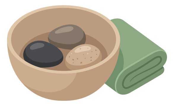 Spa bowl with hot stones and folded green towel