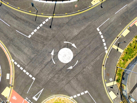 Overhead drone view of a mini roundabout. No people.