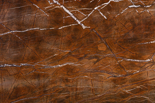 Brown marble slab texture with white and dark veins close up