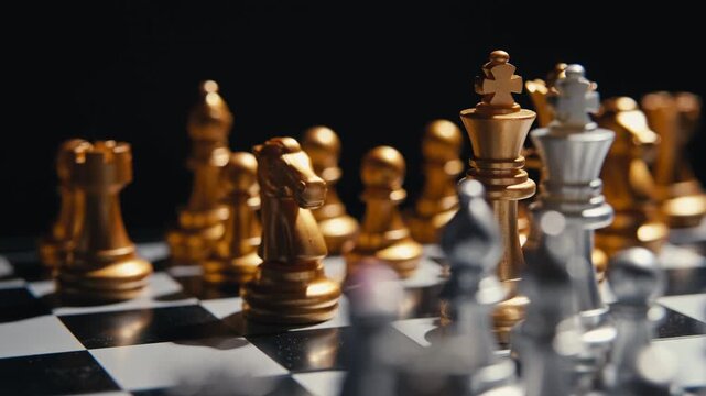 Strategic planning concept. Close-up shot of golden and silver chess pieces arranged on a checkered board against a dark background, showcasing focus, tactical thinking, and business leadership.