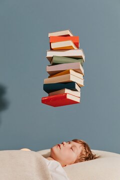Floating stack of colorful books hovering over a sleeping child in a dim bedroom, featuring a calm atmosphere with copy space for a health program
