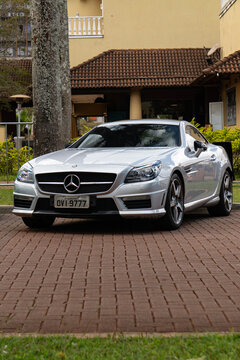 Silver Mercedes Benz SLK 55 AMG front three quarters view, High performance compact roadster parked outdoors