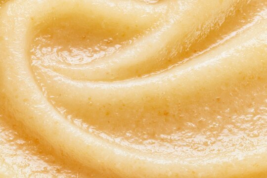 Smooth texture of creamy substance in a close up view showing waves and swirls