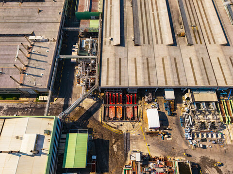 Aerial view of a large food factory complex featuring industrial rooftops, processing machinery, and storage facilities in Pomposa, Emilia-Romagna, Italy.