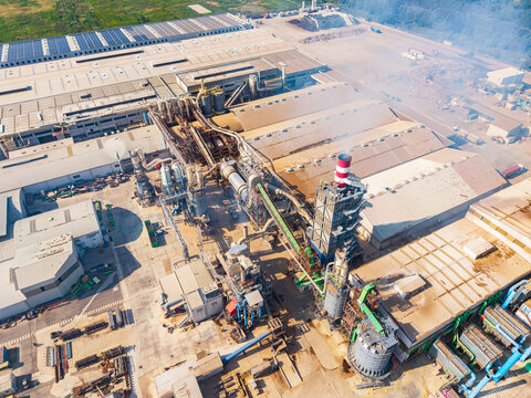 Aerial view of a large industrial food factory complex with processing machinery, storage silos, and rooftops in Pomposa, Emilia-Romagna, Italy.