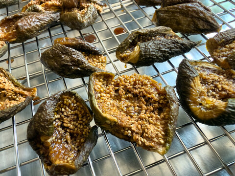 Dried dehydrated sliced fresh raw organic desert king figs ready to be stored on drying racks and metal baking sheet within oven