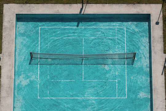 Aerial View of Tennis Court Surface Turned Into Turquoise Water