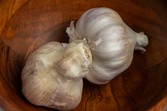 garlic at the bottom of the wooden bowl