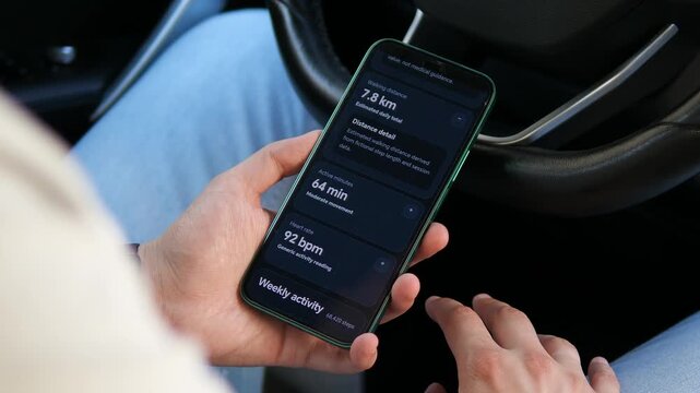 Person reviews walking distance, active minutes and heart rate on a smartphone, reflecting the rise of personal fitness analytics and data-driven wellness habits.