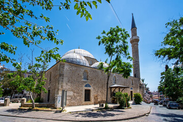Fototapeta premium Wide view of a domed mosque and minaret in central Antalya, Turkey.