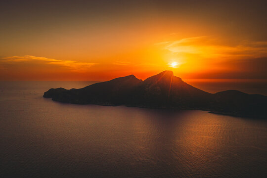 Sant Elm, Balearic Islands, Spain - 12 August 2026: Aerial view of the 2026 solar eclipse reaching totality over Sa Dragonera island, with the sun casting a golden glow over the sea.