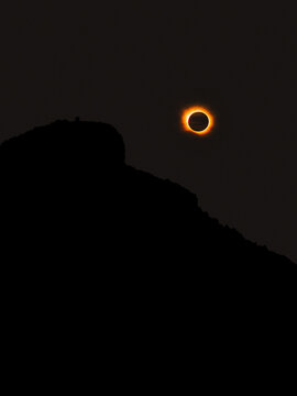 Sant Elm, Spain - 12 August 2026: Aerial view of the total solar eclipse over the silhouette of Sa Dragonera island, showing the corona and dark moon against the twilight sky.