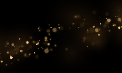 Bright gold bokeh circles shine against black. Glittering dust adds texture. Modern festive background for design. © Extrastock