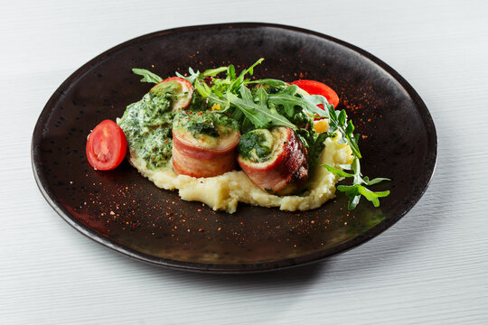 Bacon-Wrapped Meat Roulades with Herb Filling and Creamy Mashed Potatoes