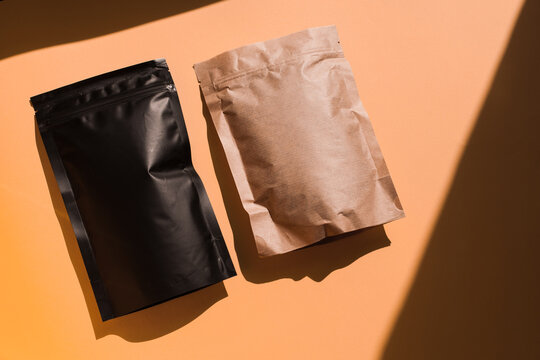 Blank craft plastic pouch, white pack on studio background with shadow, mylar bag isolated for coffee or food, cosmetic products, snack, candy. Different sizes, mock up.