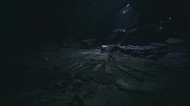 Abandoned cavern floor with wooden spokes, dim shaft light cutting through dusty air, scattered stones and damp textures evoking longforgotten machinery
