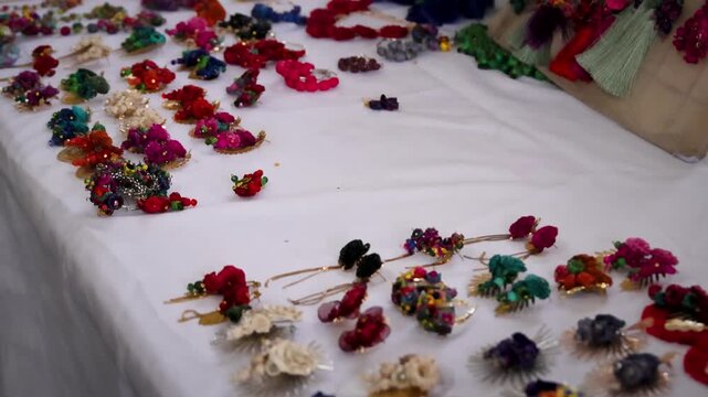 Handmade Mexican Floral Jewelry And Accessories Displayed On Market Table