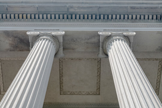 Paired Ionic columns form a symmetrical Treasury Building portico detail from below.