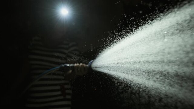 Watering a garden secretly when it is forbidden during a drought