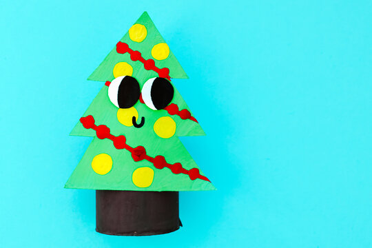 Christmas toy from toilet tube roll, paper toy santa claus, snowman, reindeer, tree rabbit on yellow background. Holiday easy kids DIY, decoration idea for winter season, home party. Children's crafts