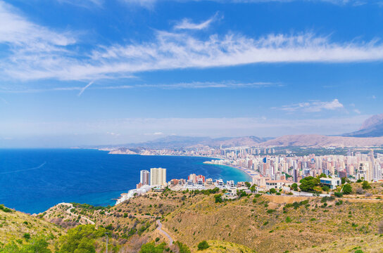 Benidorm cityscape, aerial panoramic view of Old town Benidorm city historic centre coastline with skyscrapers, hotel buildings, beach on Costa Blanca coast Mediterranean Sea in summer day, Spain