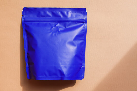 Blank craft plastic pouch, white pack on studio background with shadow, mylar bag isolated for coffee or food, cosmetic products, snack, candy. Different sizes, mock up.