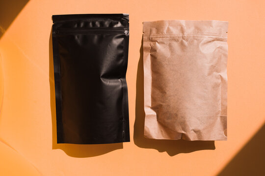Blank craft plastic pouch, white pack on studio background with shadow, mylar bag isolated for coffee or food, cosmetic products, snack, candy. Different sizes, mock up.