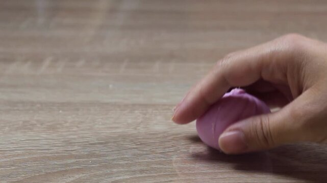 Girl picking up and throwing an anti-stress dumpling toy