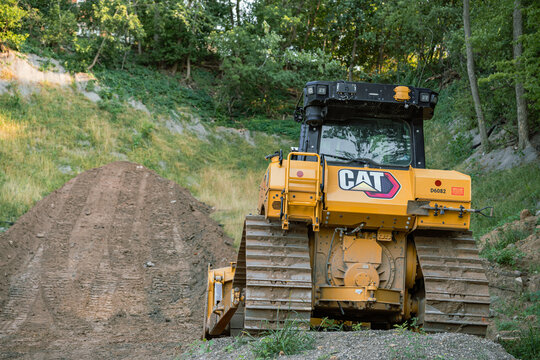 Caterpillar track-type tractor bulldozer working on a dirt slope in Minnesota on August 10, 2026. Editorial Use Only.
