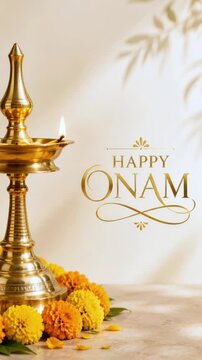 Happy onam greeting beside a brass nilavilakku plus marigold flowers under copy space