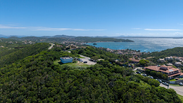 Aerial view of Mirante das Ilhas overlooking the lush green hills and the coastal bay with boats in Armacao dos Buzios, Rio de Janeiro, Brazil.