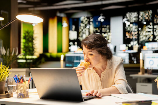 Corporate analyst eats unhealthy food while working late at night, dealing with stress eating and compulsive overeating caused by hard work after hours.