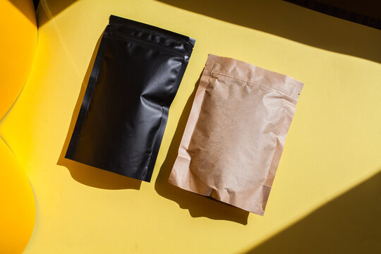 Blank craft plastic pouch, white pack on studio background with shadow, mylar bag isolated for coffee or food, cosmetic products, snack, candy. Different sizes, mock up.