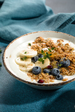 Eating granola with greek yogurt and berries