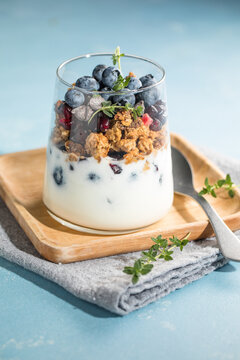 Yogurt with muesli or granola and fresh strawberries for healthy breakfast or snack.
