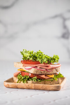 Ham sandwich isolated on white. Selective focus on the sandwich