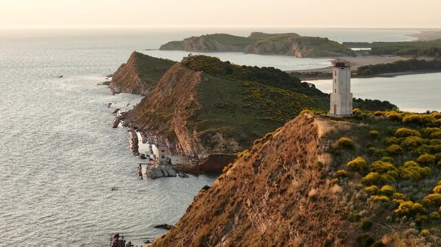 Aerial view of the Zvernec lighthouse perched on a rugged cliff overlooking the Adriatic Sea in Zvernec, Vlore County, Albania.