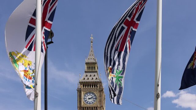 London, Tower of Big Ben on Parliament Square with flags waving in front of it, Great Bell of Clock