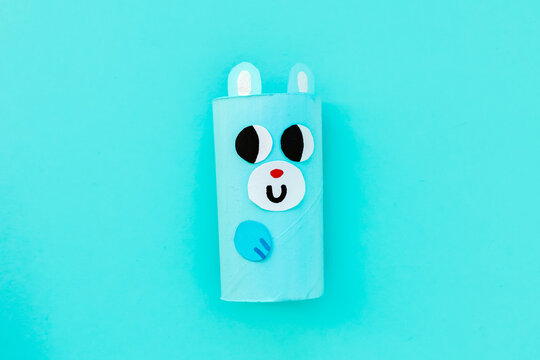 Christmas toy from toilet tube roll, paper toy santa claus, snowman, reindeer, tree rabbit on yellow background. Holiday easy kids DIY, decoration idea for winter season, home party. Children's crafts
