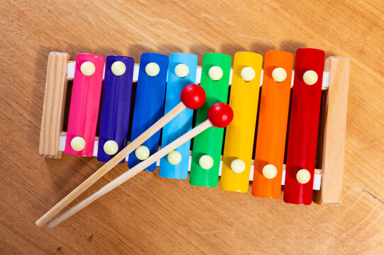Children multi-colored xylophone with sticks on a wooden background
