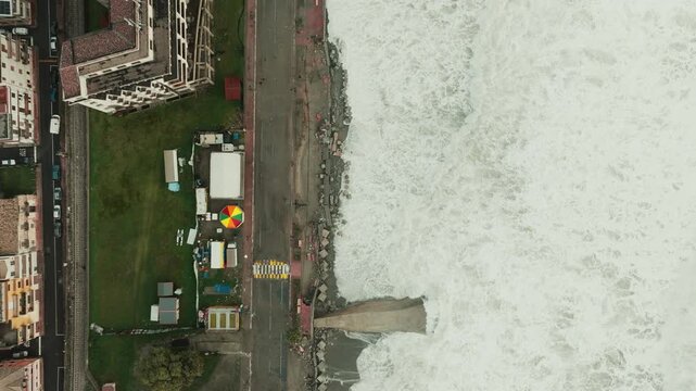 Ocean waves destroy road near beach, climate change aerial view