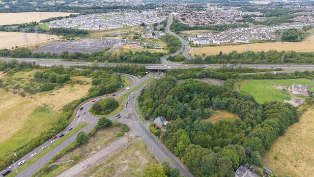 Bird's-eye view of Straiton Junction on A720 Edinburgh City Bypass showing residential suburbs and road network, Scotland