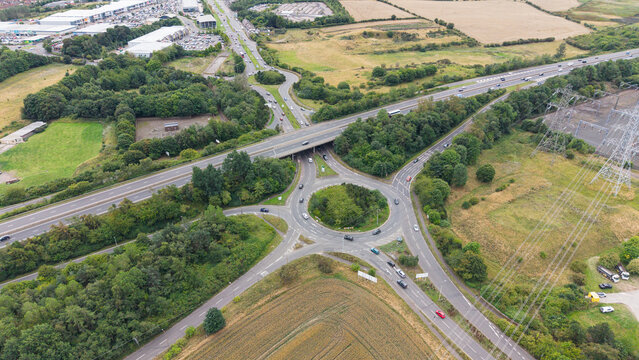 Aerial view of Straiton Junction roundabout with traffic near Straiton Retail Park on A720 Edinburgh City Bypass, Scotland