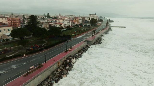 Ocean waves crash violently onto a waterfront destroyed by climate change