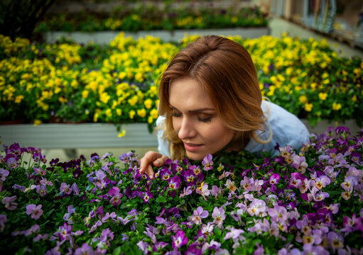 Woman Smelling Purple Flowers.